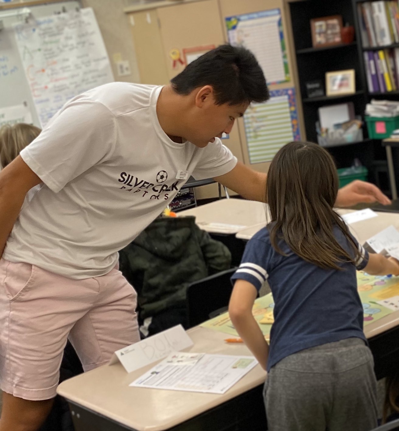 High School leader working with elementary student